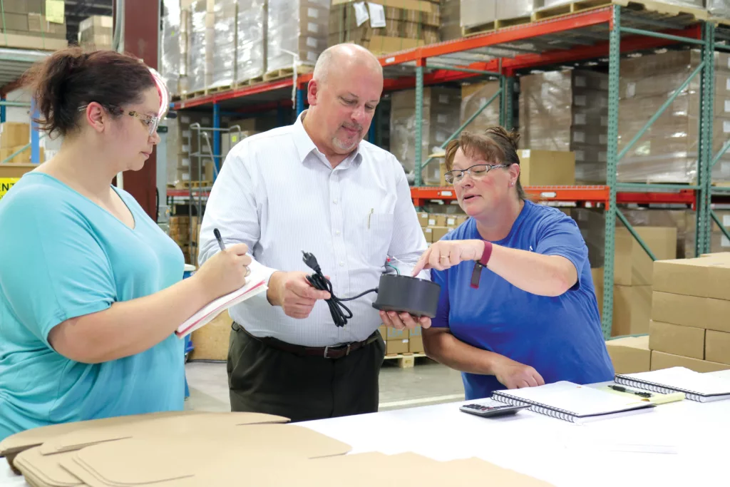 People inspecting a product assembly